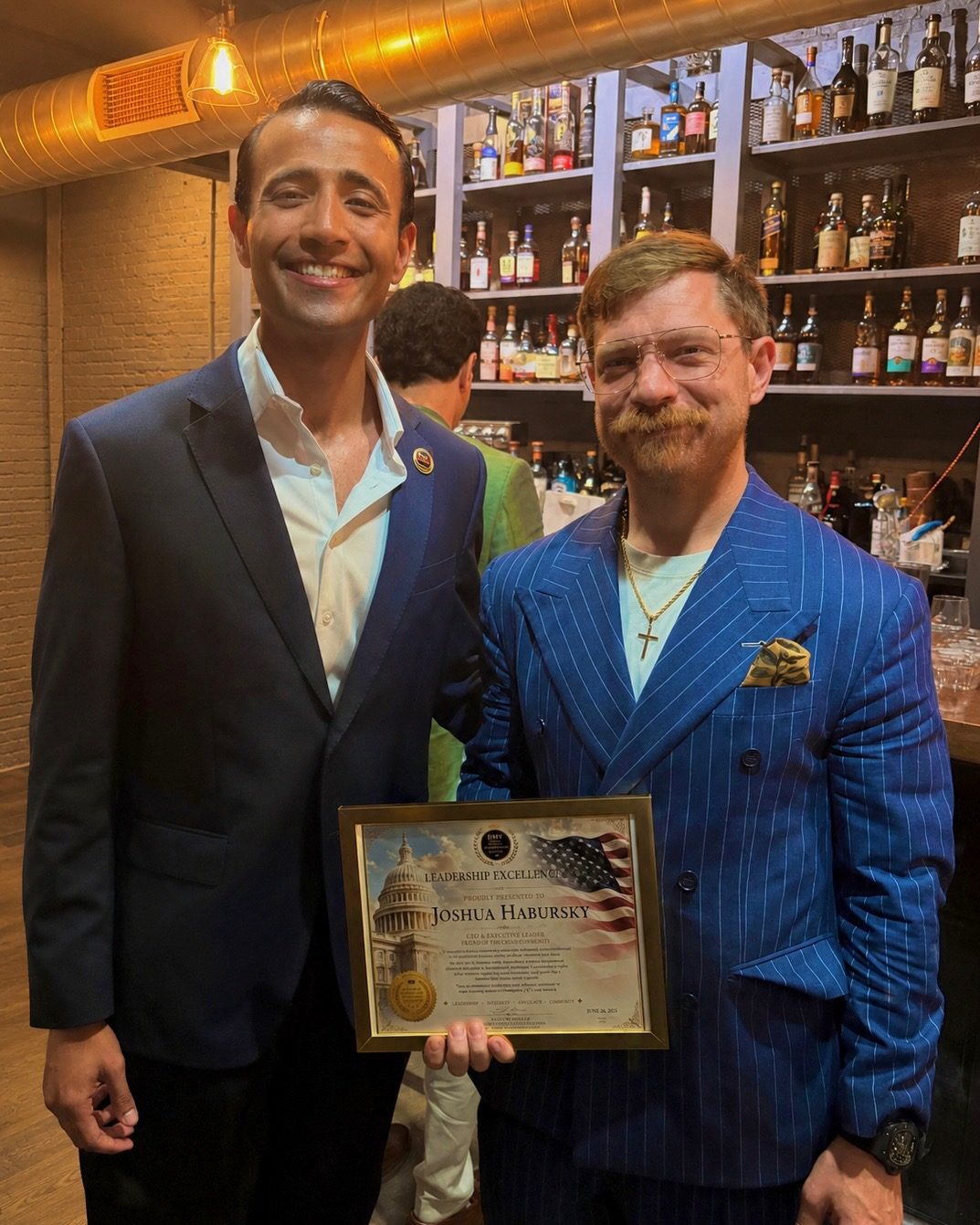Zach Mehmood presenting Joshua Habursky, CEO of the Premium Cigar Association, with a Leadership Excellence award